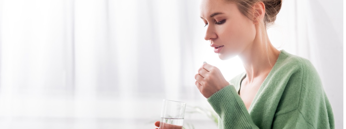 woman taking prescription pills