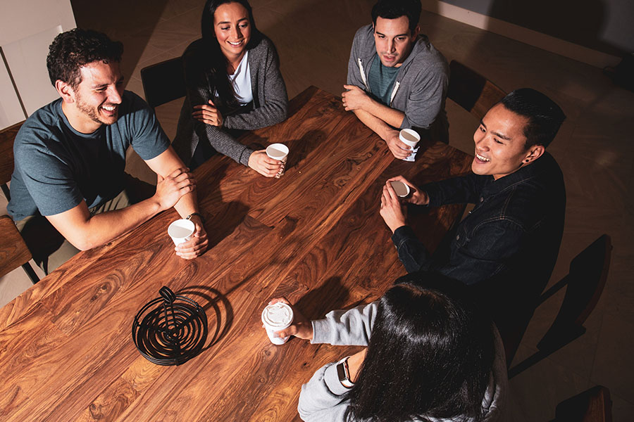 group of young adults chatting at the dining table after completing heroin detox treatment